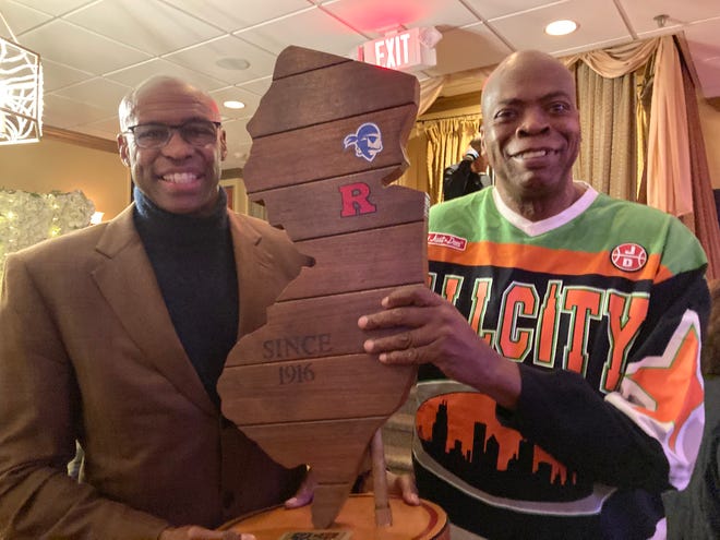 Former Rutgers standout Hollis Copeland (left) and former Seton Hall standout Glenn Mosley (right) hold the Boardwalk Trophy at the 2022 RU-SHU Hoops Banquet