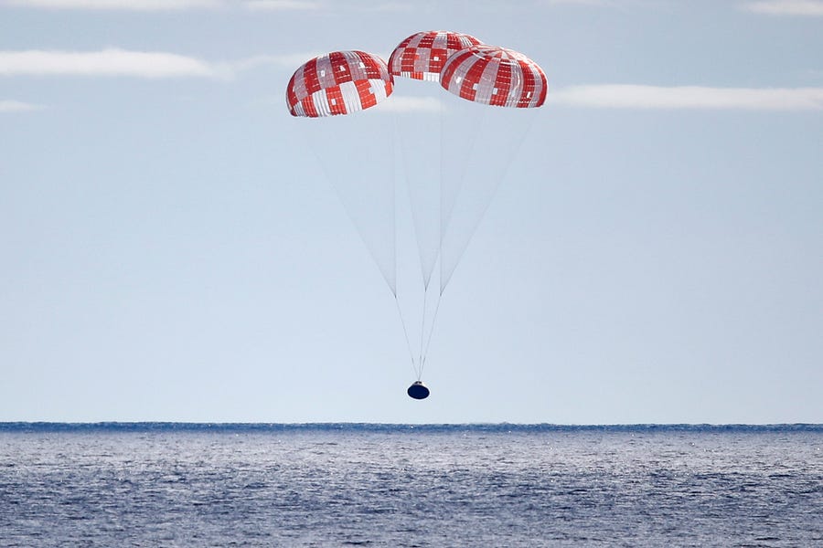NASA's Orion Capsule splashes down after a successful un-crewed Artemis I Moon Mission on December 11, 2022 seen from aboard the U.S.S. Portland in the Pacific Ocean off the coast of Baja California, Mexico. The 26-day mission took the Orion spacecraft around the moon and back, completing a historic test flight coinciding with the 50th anniversary of the landing of Apollo 17 on the moon, the last time NASA astronauts walked there.