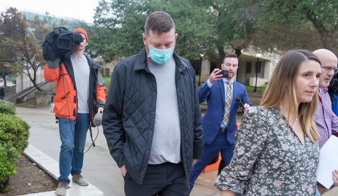 Texas Longhorns men's basketball coach Chris Beard walks out of the Travis county Jail with his Defense Attorney Perry Q. Minton on Monday afternoon Dec. 12, 2022. Chris Beard who is faces a domestic assault charge. Beard was booked into jail at 4:18 a.m. Monday, according to the Travis County sheriff's office jail records. Beard faces a third-degree felony charge of assault on a family/household member-impede breath circulation.