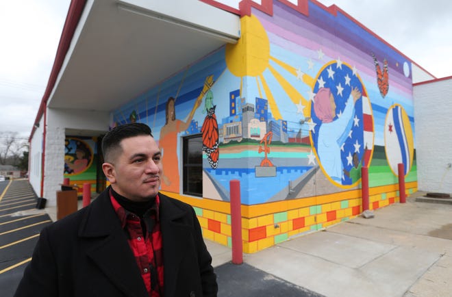 Artist Freddy Rodriguez stands before the formal dedication Dec. 12, 2022, of his mural on the La Casa de Amistad building at 3423 S. Michigan St. in South Bend.