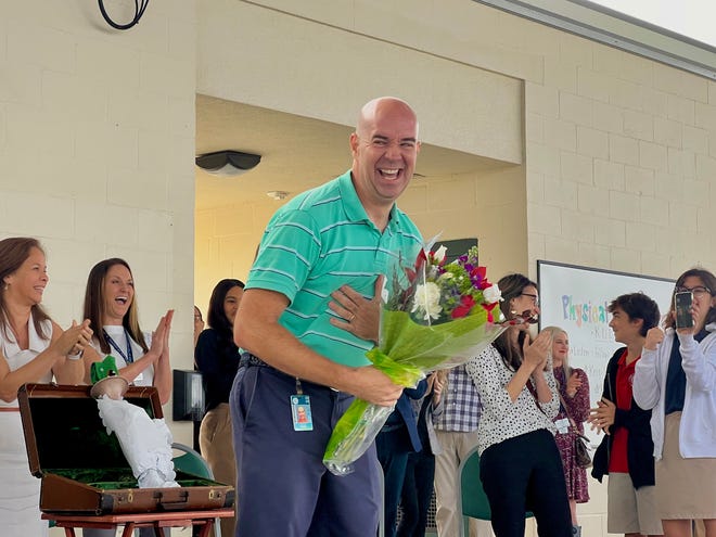 Tim Ferguson, a music teacher at Garden Elementary School in Venice, was surprised by district staff and the Education Foundation of Sarasota County on Monday, Dec. 12, 2022.