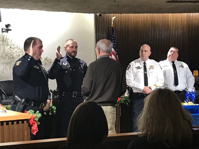 Officer Thayne Telquist, at left, and Officer Joseph Gladden were promoted to sergeant Monday at Mansfield Council Chambers. Administering the oath is Dave Remy, interim safety-service director, joined by Mansfield police Chief Keith Porch and Assistant Mansfield police Chief Jason Bammann.
