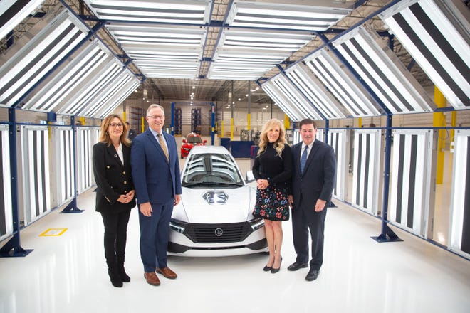 Gov. Doug Ducey, Mesa Mayor John Giles and ElectraMeccanica CEO Susan Docherty stand next to a SOLO electric vehicle model.