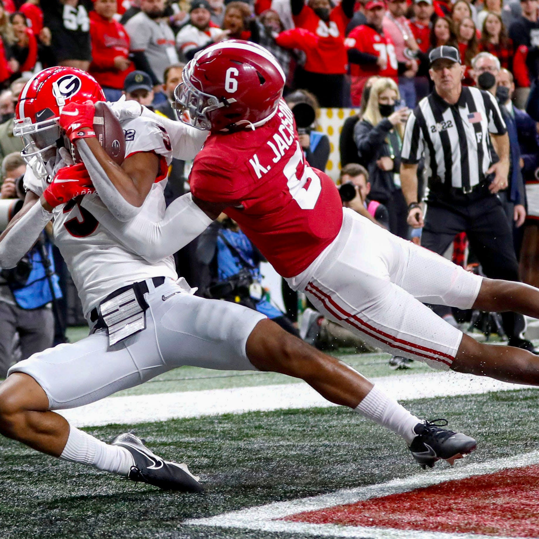 January 10, 2022: Indianapolis, IN, USA; Georgia Bulldogs wide receiver Adonai Mitchell (5) catches a touchdown pass while being guarded by Alabama Crimson Tide defensive back Khyree Jackson (6) during the College Football Playoff National Championship at Lucas Oil Stadium in Indianapolis.