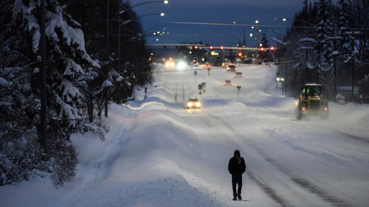 An overnight storm dropped at least a foot of new snow on Anchorage, Alaska, closing schools and complicating driving conditions.