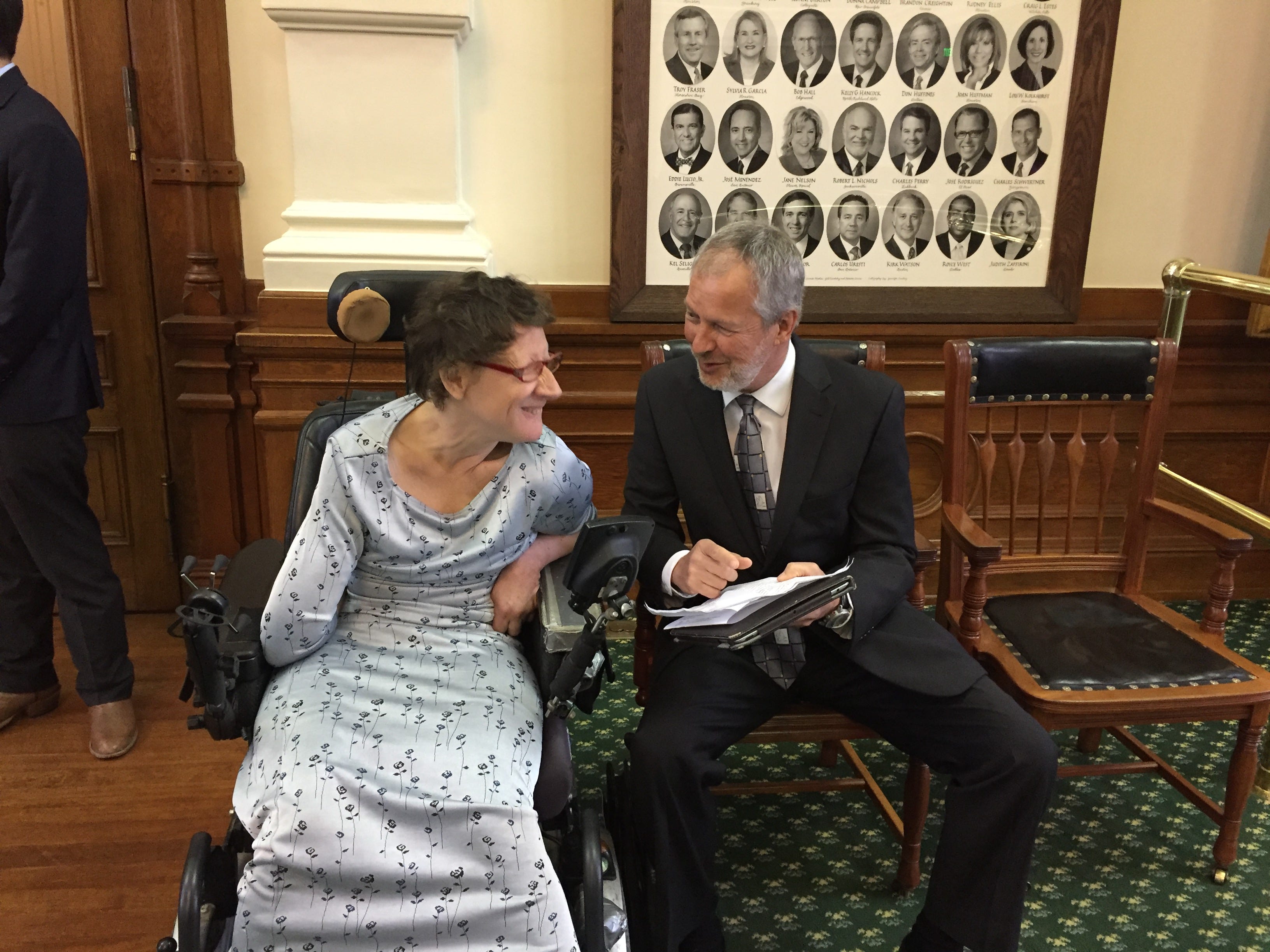 Gloria Susan Angel, a researcher and editor with cerebral palsy, speaks with Dennis Borel, executive director of the Coalition of Texans with Disabilities, at the Capitol in 2017. Angel was hospitalized three times and institutionalized in a nursing home after her caregiver died this summer, and no replacement caregiver could be found. Angel died in August.