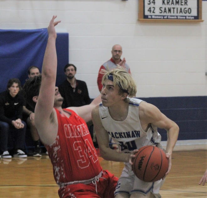 Mackinaw City senior Noah Valot (right) scored 12 points for the Comets in a home victory over Ellsworth on Monday.