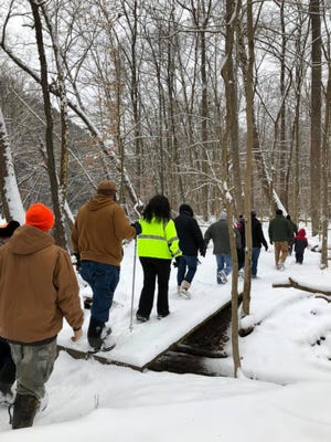 Hikers enjoy a different, snowy side of a park during this winter hike.
