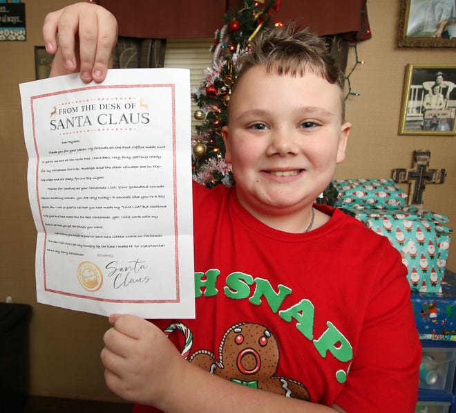 Nine-year-old Rylinn Gregory shows off the letter signed by Santa got in the mail recently at his home on Pinhook Loop Road.