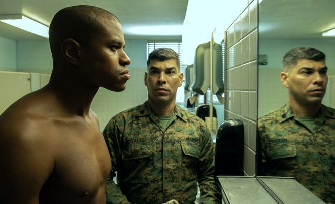 Jeremy Pope (left) plays a gay Marine Corps recruit who trusts an instructor (Raul Castillo) during boot camp in