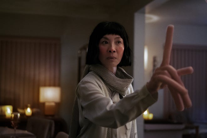 Evelyn (Michelle Yeoh) lives out several different realities, including one where she has hot dog fingers in the sci-fi comedy "Everything Everywhere All at Once."