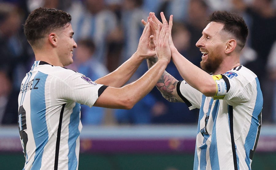 Argentina's Julian Alvarez (left) celebrates with teammate Lionel Messi after scoring a goal against Croatia during the semifinal match at Lusail Stadium.