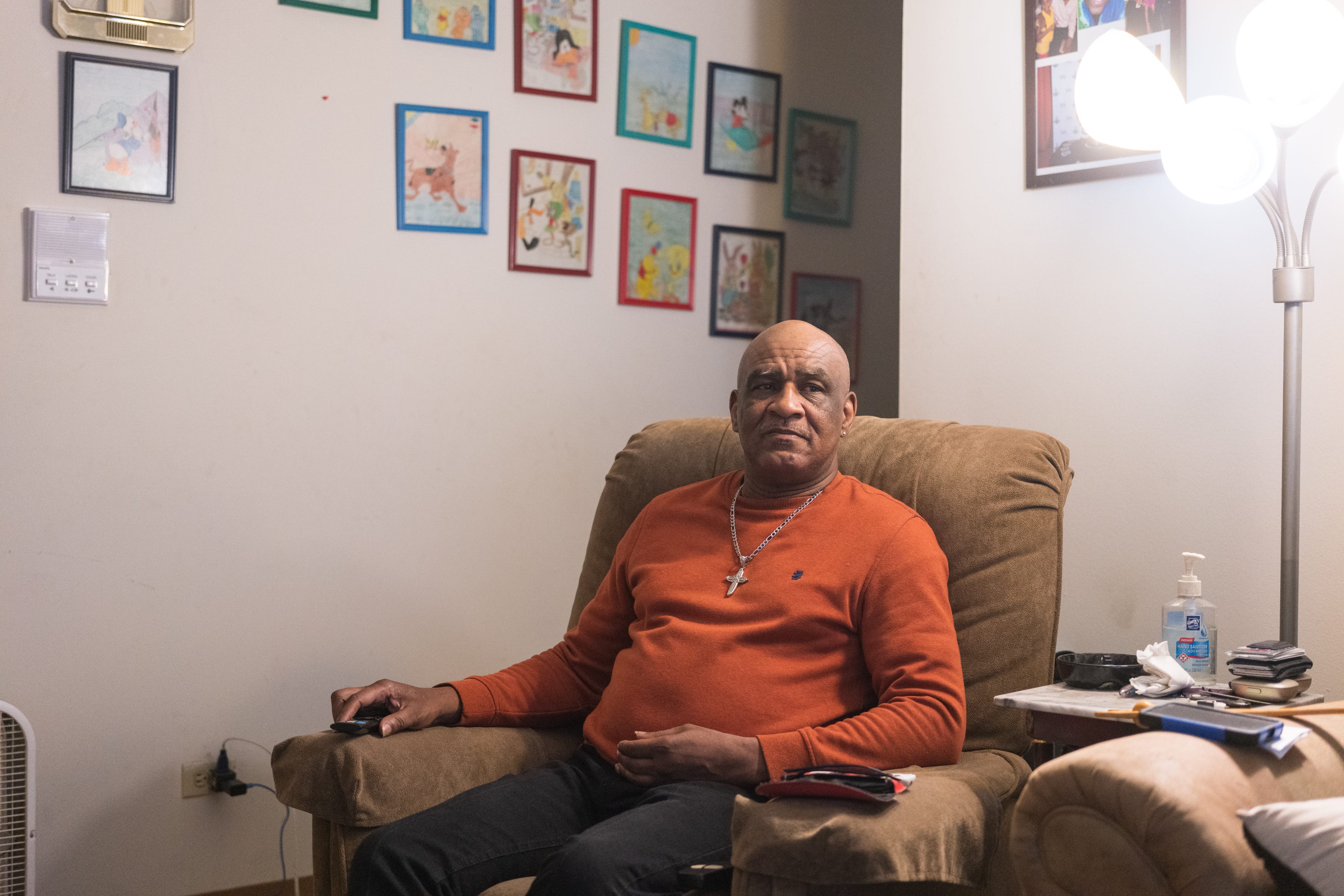 Larry Lomax, 65, sits inside his apartment in Waukegan, Illinois, on Dec. 11, 2022.