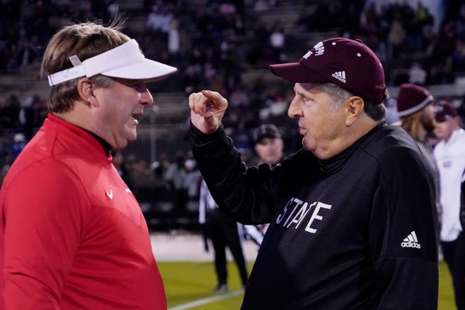 Georgia head coach Kirby Smart, left, and Mississippi State head coach Mike Leach, confer prior to an NCAA college football game in Starkville, Miss., Saturday, Nov. 12, 2022. (AP Photo/Rogelio V. Solis)