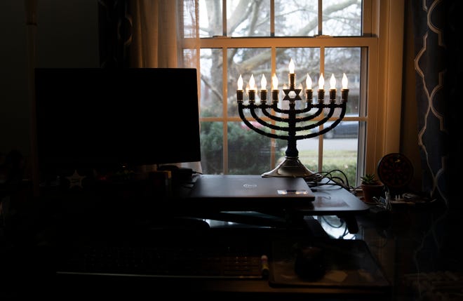 Dec 14, 2022; Worthington, Ohio, USA;  A menorah sits in the window of Andrea and Stephen Brichter in their Worthington home that is decorated for Hanukkah. Mandatory Credit: Brooke LaValley-The Columbus Dispatch