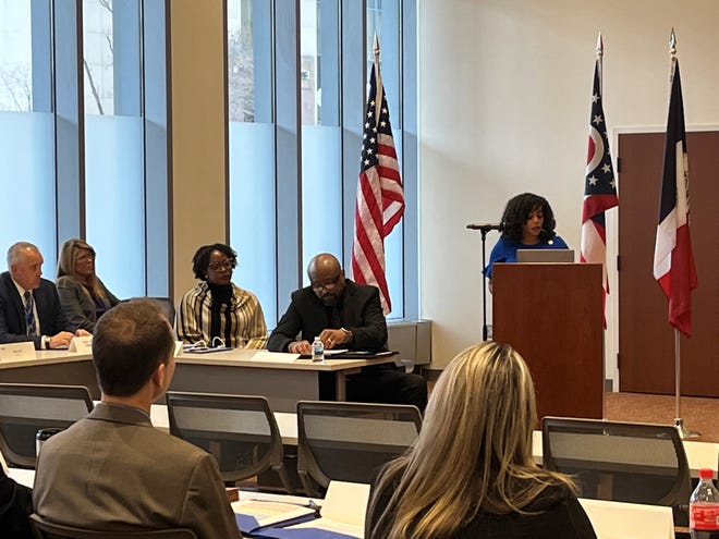 Franklin County Board of Commissioners President Erica Crawley, right, welcomes attendees of the county Criminal Justice Planning Board meeting Wednesday at the Michael J. Dorrian Building in Columbus.