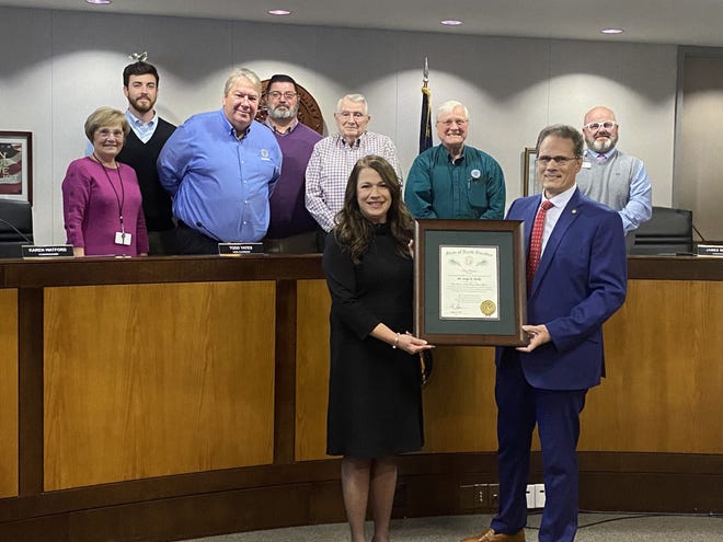 Retired educator and Davidson County resident Dr. Sonja Parks (front, left) is presented the Order of the Long Leak Pine award from NC Sen. Steve Jarvis (front, right) at the Davidson county Board of Commissioners meeting Monday night. The commissioners are pictured standing behind Parks.