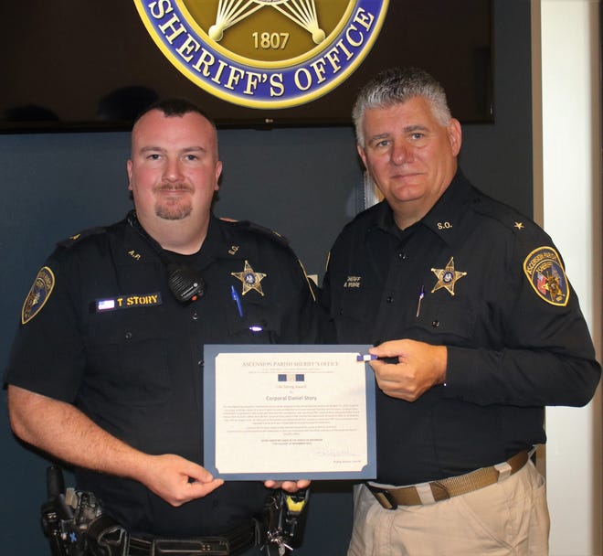 Corporal Daniel Story received the Life Saving Award while serving in the school security section for the Ascension Parish Sheriff's Office. Story is shown with Sheriff Bobby Webre.