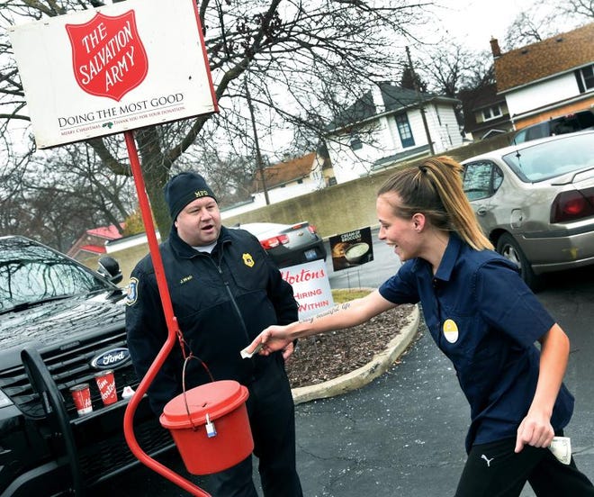 City of Monroe Police Capt. J.D. Wall rings the Salvation Army bell for the Red Kettle campaign in 2018 as Mirah Ayers makes her donation.
Bellringers are greatly needed this year.