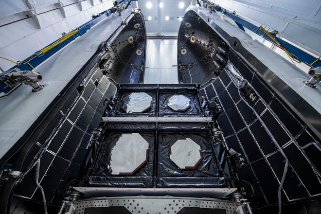 The SES O3b mPower 1 and 2 satellites for Luxembourg satellite operator SES are seen during payload integration into the protective SpaceX Falcon 9 payload fairing before being mated with the Falcon 9 booster.