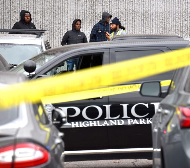 Standing outside the Faurecia factory in Highland Park on the afternoon of Wednesday, December 14, 2022, police investigate a mass shooting in the front parking lot.
