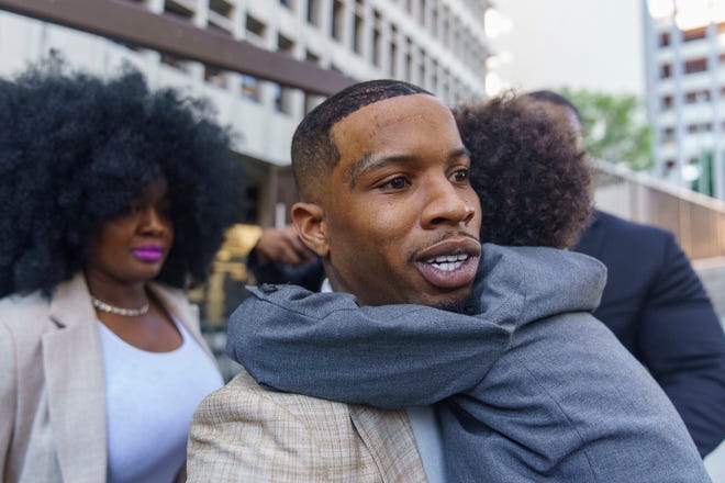 Rapper Tory Lanez, 30, walks out of the courthouse while holding his 5-year-old son Kai'Lon, Tuesday, Dec. 13, 2022, in Los Angeles.