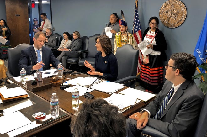 State schools Superintendent Joy Hofmeister speaks Thursday while supporters of Sovereign Community School in tribal regalia look on during an Oklahoma State Board of Education meeting in Oklahoma City.