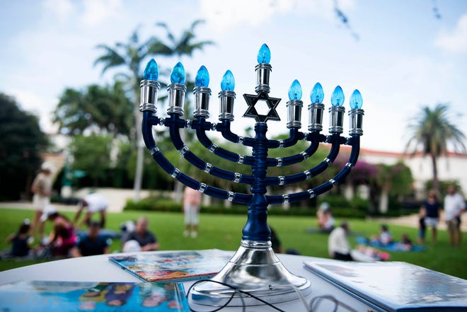 Guests arrive Thursday at the Philip Hulitar Sculpture Garden on the campus of the Society of the Four Arts for Preschool Story time celebrating Hanukkah.