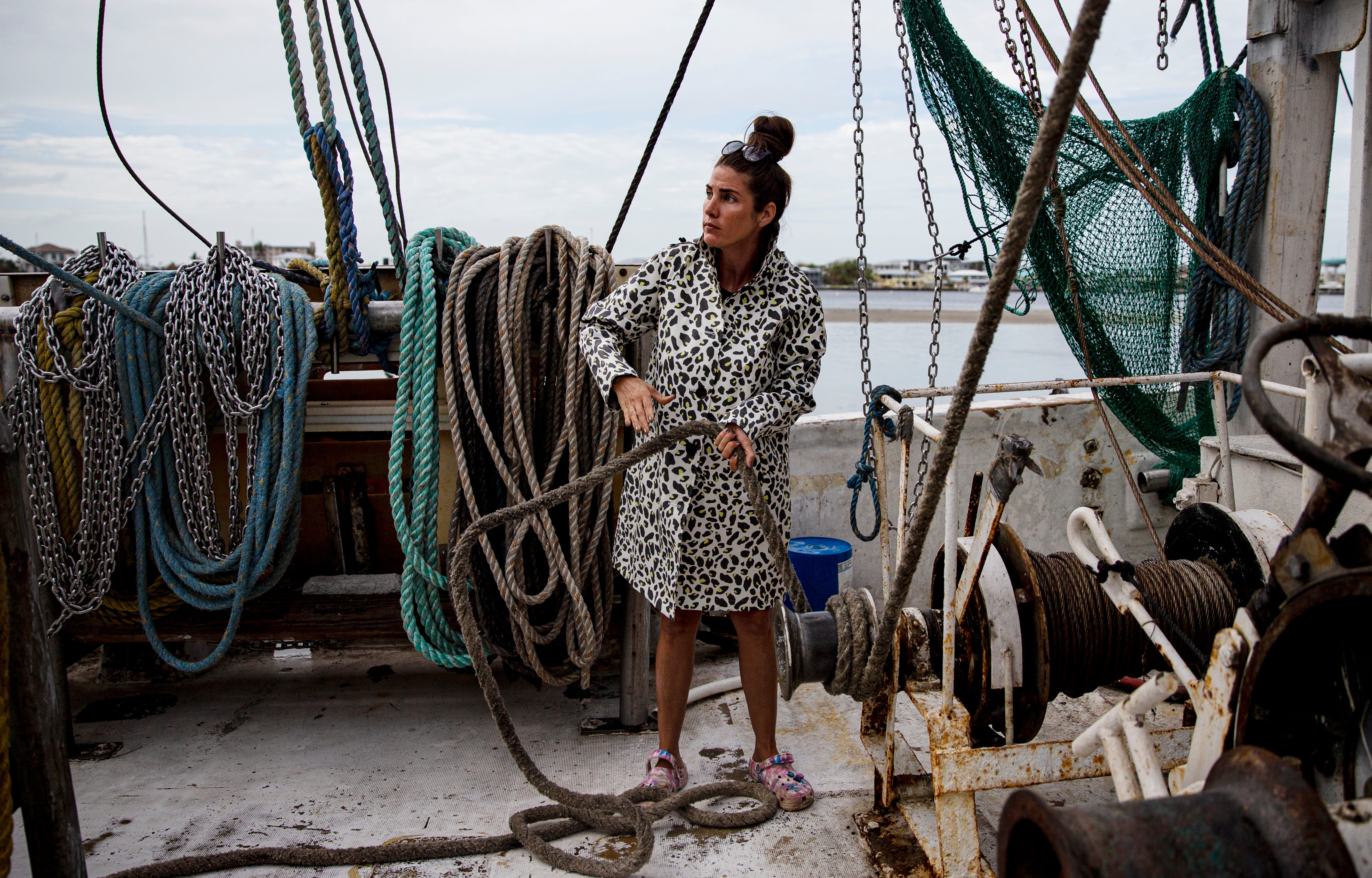 Anna Erickson helps unload shrimp from the Malolo on Nov. 9, 2022. The Malolo was one of the only boats that was not damaged or destroyed in Hurricane Ian and was the first boat to go out fishing after the storm. It was also the first one back.  Erickson, a fourth generation shrimper, heads up Erickson & Jensen Shrimp Packers with her father, Grant.