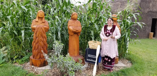 Eliza Skenandore in front of the three sisters' garden she helped plant and care for on the Oneida Cultural Heritage Grounds