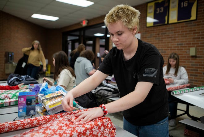 Shelby Barlow, 14, wraps Christmas presents with other students at Millersport Junior/Senior High School during the annual White Christmas project through the Walnut Township Local School District on Dec. 14, 2022 in Millersport, Ohio. Students wrap gifts for those in need and the presents are distributed around the community for Christmas.