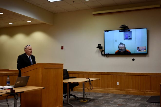 Assistant Attorney General John Pallas, left, appears in Judge Suzanne Geddis' courtroom on Thursday, Dec. 15, 2022, to argue for a delay to the release of Floyd Jarvi Jr., pictured on the screen. Geddis ordered the Michigan Department of Corrections to halt plans for his release until an appeal hearing of the Michigan Parole Board can be held.