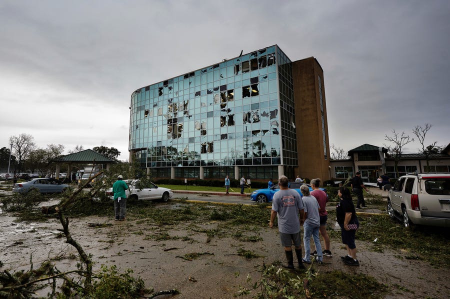 People survey damage following a tornado at the Iberia Medical Center, Wednesday, Dec. 14, 2022, in New Iberia, La.