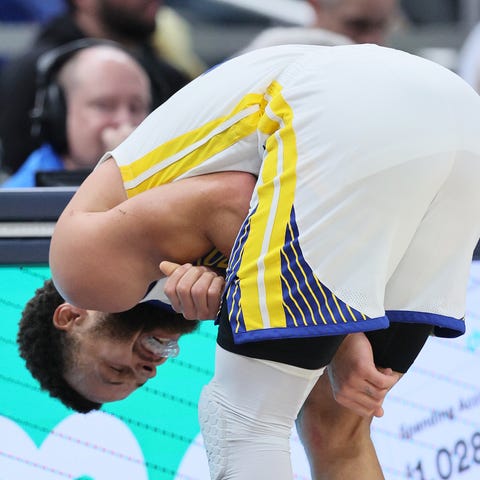 Warriors guard Stephen Curry grimaces after being 