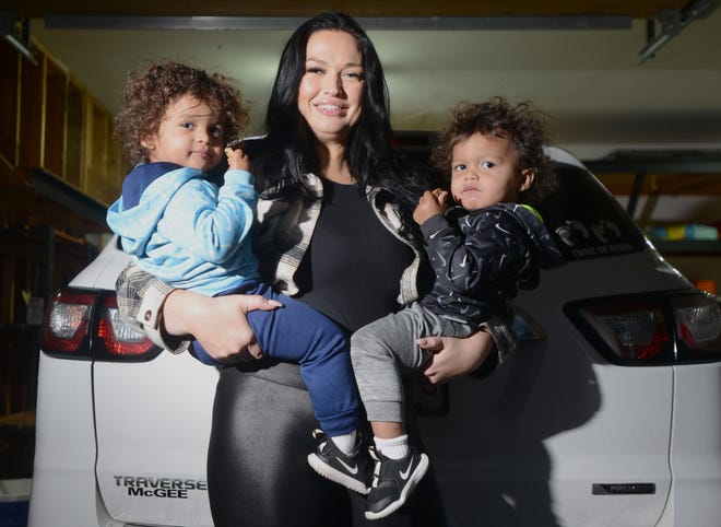 Cara McNeil stands with her twins Micah, left, and Jacobie, beside the car she was driving during a road incident with another driver in November. Both McNeil and the other driver, Jeanne Pozerski of Sandwich, now face clerk-magistrate hearings.
