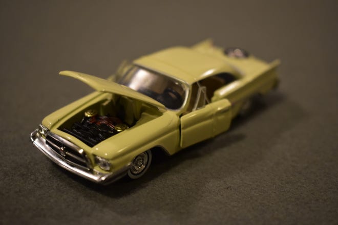 1/64 diecast model of the 1960 Chryser Imperial, partially in focus
