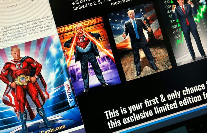 The photo illustration created on December 15, 2022 shows computer screens displaying former President Donald Trump's recently released digital trading card collection as revealed in an online announcement on his platform.