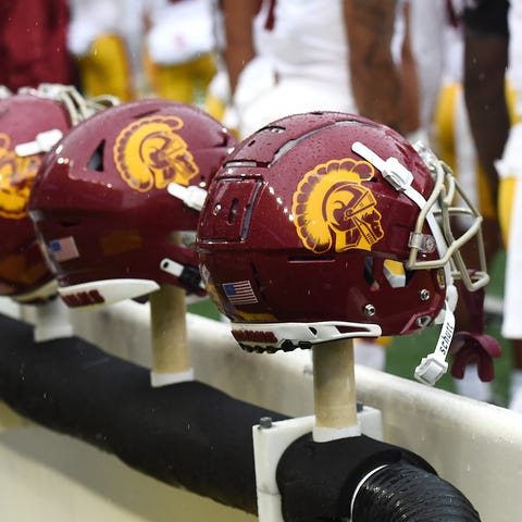 USC Trojans helmets sit on the sideline.