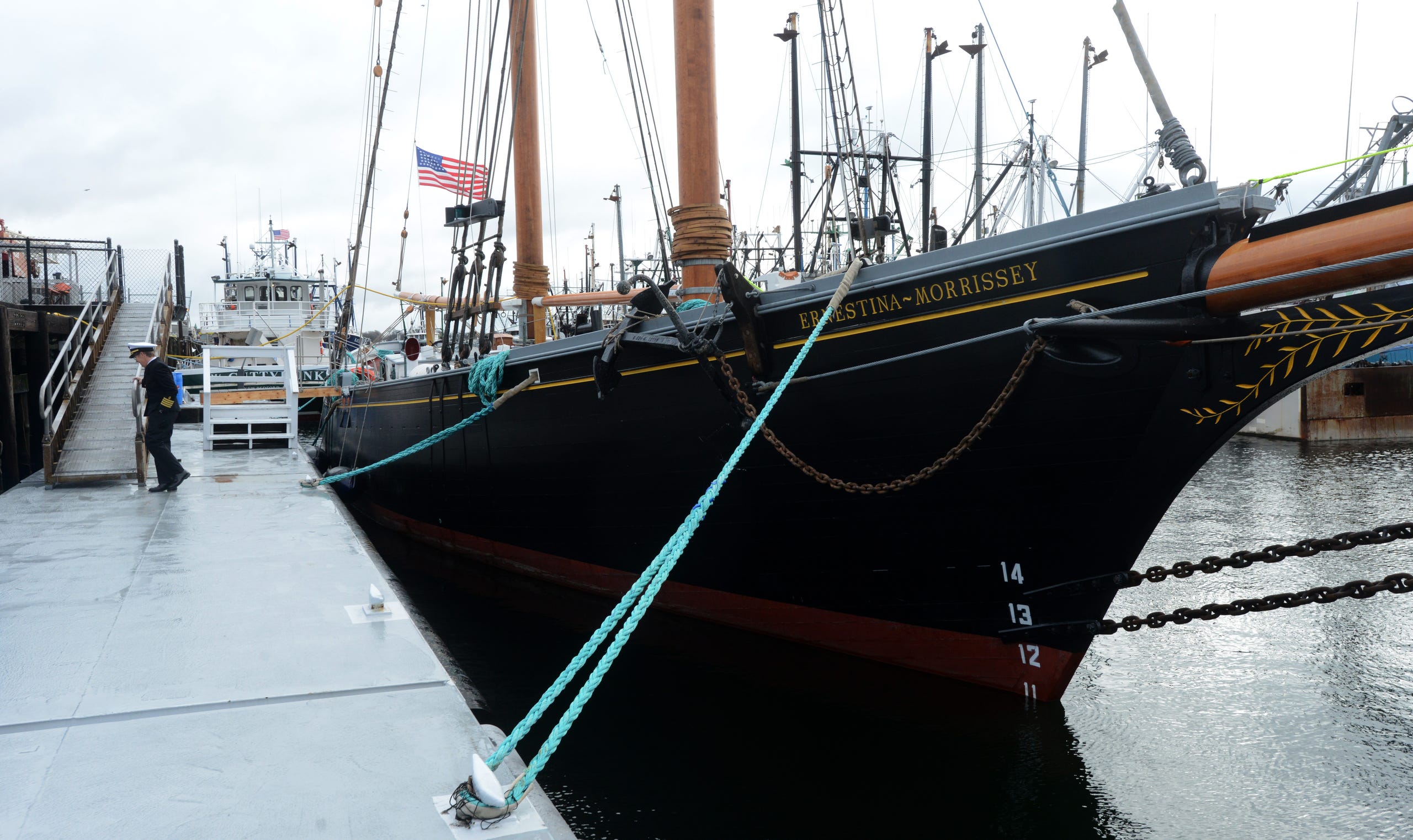 NEW BEDFORD 12/17/22 Captain Tiffany Krihwan, left, heads up the gangway beside the tall ship Ernestina-Morrissey during a homecoming celebration for the tall ship at the State Pier in New Bedford on Saturday. Steve Heaslip/Cape Cod Times