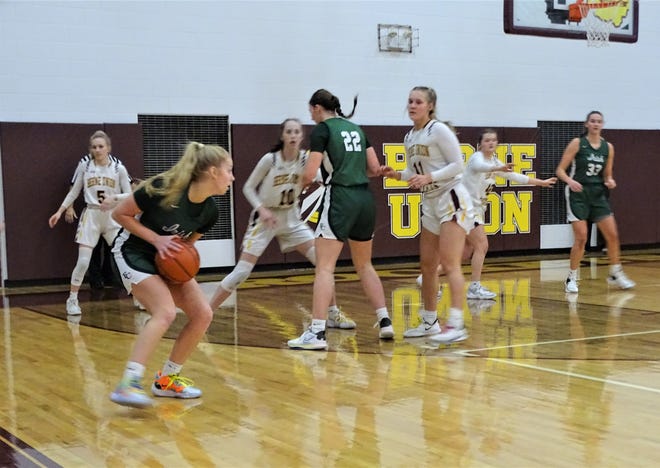 Fisher Catholic's Voni Bethel looks to pass the ball to a team as Berne Union's Baylee Mirgon and Sophia Kline defend during the Rockets' 34-28 Mid-State League-Cardinal Division win on Saturday.
