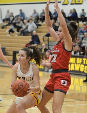 Tri-Valley's PD Moore looks for a teammate against Sheridan's Nora Saffell in Saturday's game. The Scotties won 55-45.