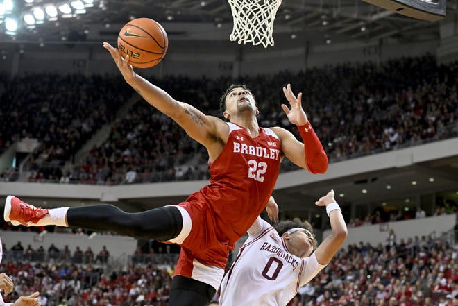 Bradley forward Ja'Shon Henry (22) is founded by Arkansas guard Anthony Black (0) as he drives to the basket during the second half of an NCAA college basketball game, Saturday, Dec. 17, 2022, in North Little Rock, Ark. (AP Photo/Michael Woods)