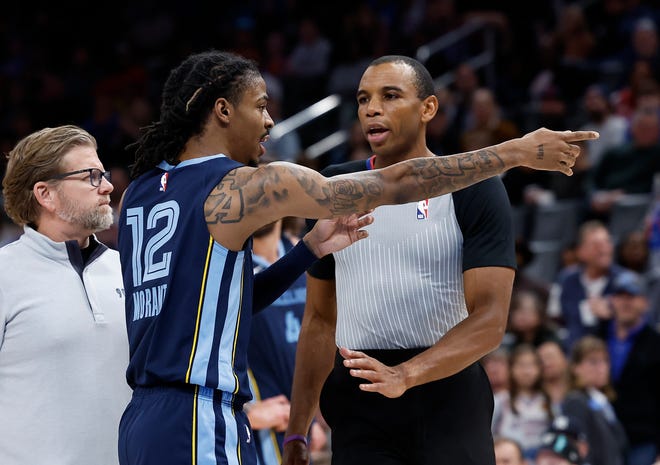Memphis Grizzlies guard Ja Morant (12) points to fans before being ejected from the game following a play against the Oklahoma City Thunder during the second quarter at Paycom Center. Mandatory Credit: Alonzo Adams-USA TODAY Sports
