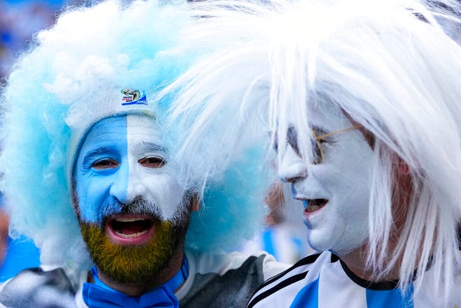 Argentinian fans cheer before the the World Cup final soccer match between Argentina and France at the Lusail Stadium in Lusail, Qatar, Sunday, Dec. 18, 2022. (AP Photo/Petr David Josek)