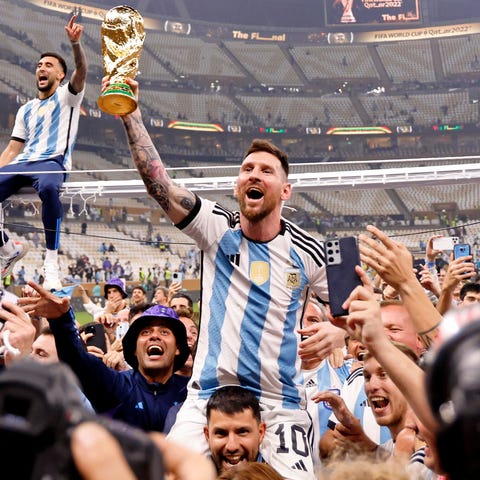 Argentina players carry Lionel Messi on their shou