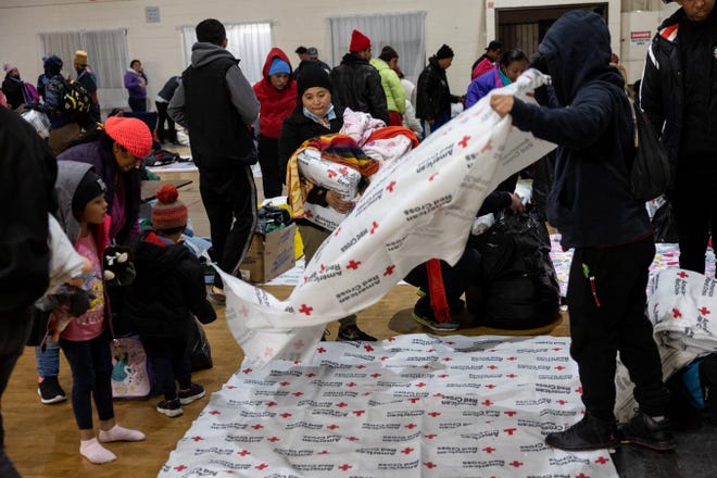 Immigrants bed down for the night in a gymnasium shelter at the Sacred Heart Church on December 17, 2022 in El Paso, Texas.