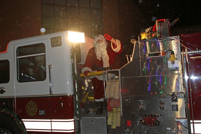 Santa arrived in Elmore on Saturday night. He braved blustery subfreezing temperatures, while riding on the back of a Harris-Elmore Fire Department truck, leading a parade through the streets of Elmore. The parade ended at Woodmore High School, where he met with children, and posed for photos.