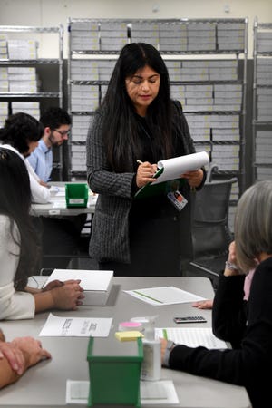 Mayra Enriquez, of the Ventura County Elections Division, supervises as election workers conduct a recount of the Ojai mayor's race at the Ventura County Government Center on Monday, Dec. 19, 2022. Only 42 votes separated incumbent Betsy Stix from challenger Anson Williams.