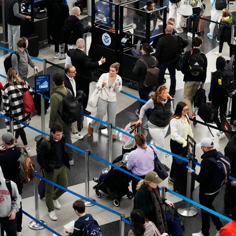 Travelers wait to go through security check point 