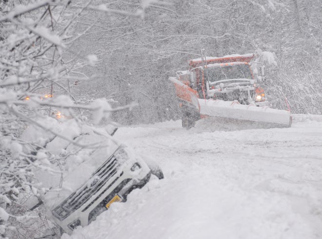 A state plow truck clears snow along Route 30 in Jamaica, Vt., on Dec. 16, 2022.